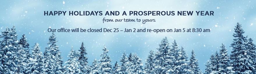 Winter scene of the top of pine trees with the sky at twilight.