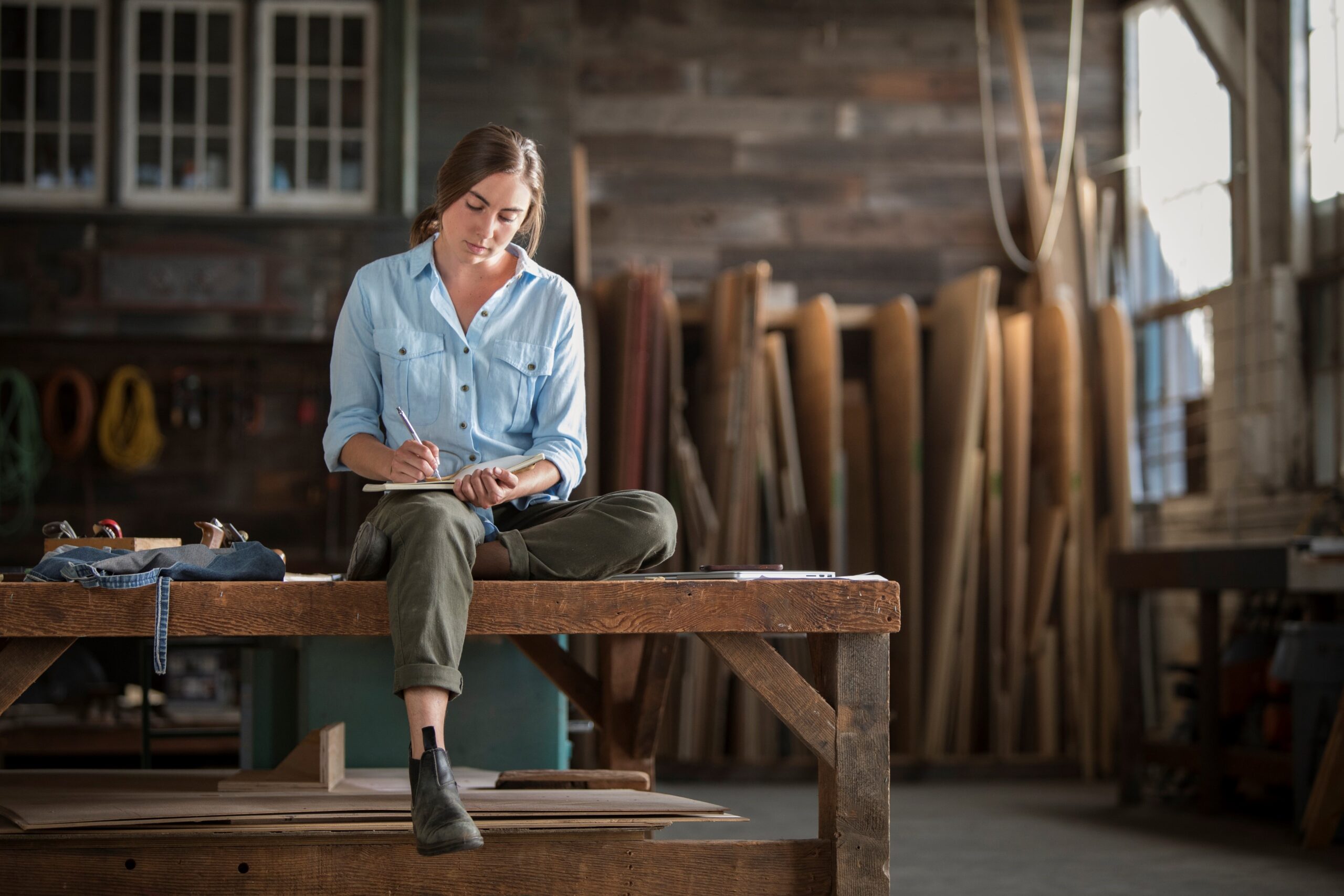 Woman architect sitting on a bench and sketching a design