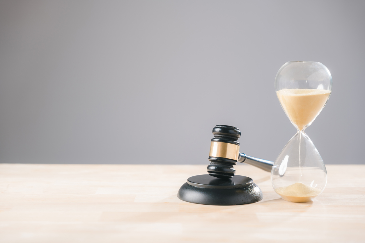 Judge's gavel beside an hourglass symbolizing litigation timelines, legal deadlines, and limitation periods in construction disputes.